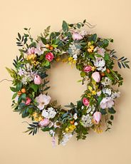 Spring wreath made with artificial poppies, cherry blossoms, orchids, freesia, tulips, ranunculus, and kumquats