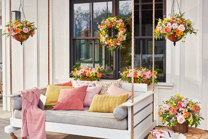 Front porch decorated with assorted artificial flowers