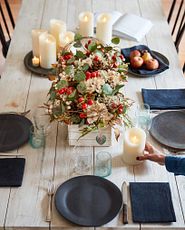 Tablescape with foliage, candles, and dinnerware
