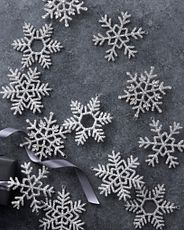 Set of beaded snowflake Christmas ornaments on a gray background