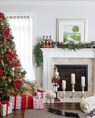 Living room with Christmas tree and fireplace mantel decorated for Christmas