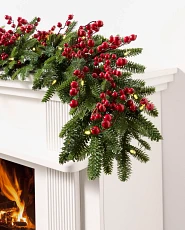 Garland with red berries draped over white mantel