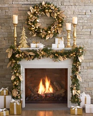 White and stone fireplace mantel decorated with gold Christmas accents