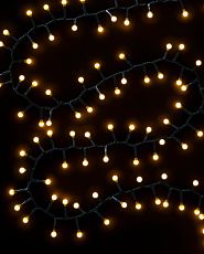 Christmas light string against a black background