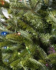 Close-up image of artificial Christmas tree with colorful LED lights.