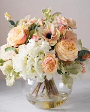  Artificial flower arrangement with hydrangeas, anemone, and roses in clear glass vase