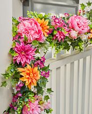 Closeup of an artificial garland with orange and pink flowers