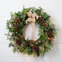 A Christmas wreath with pinecones and ribbon