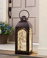 Brown decorative lantern filled with fairy lights