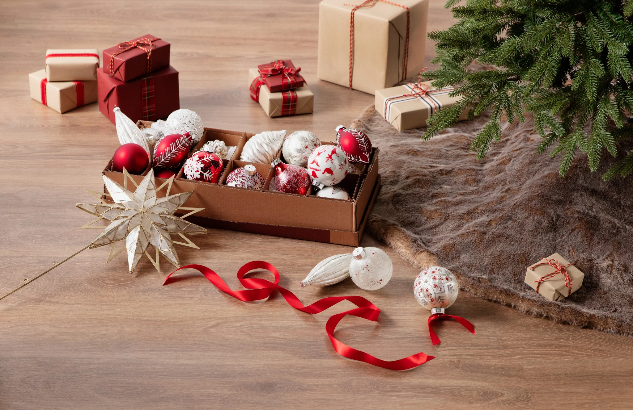 Assorted red and white Christmas ornaments in a box