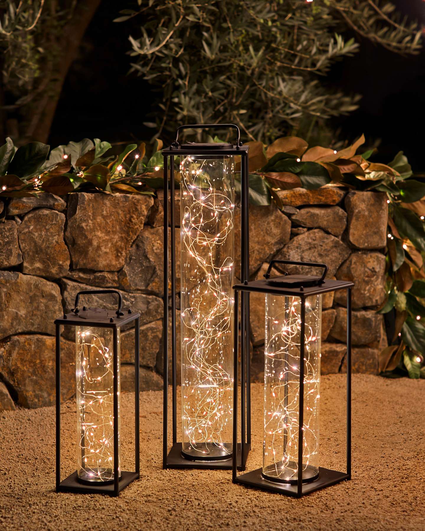 Balsam Hill Solar Fairy Light Lantern Hanging from a Tree in a Garden