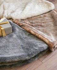 Faux fir tree skirts in gray, brown, and ivory colors