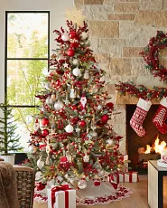 Christmas tree decorated in a Scandinavian inspired red and white theme, featuring simple ornaments and natural accents for a clean, cosy look.