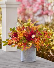 Artificial potted arrangement with dahlias, maple leaves, and wildflowers