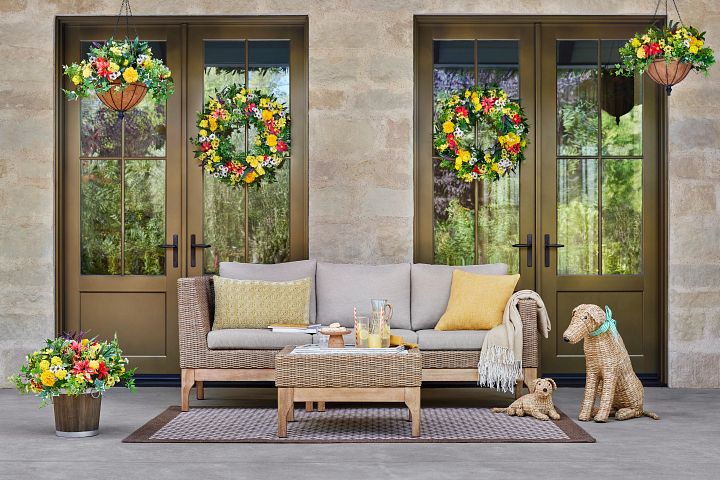 Outdoor seating area decorated with artificial dahlia wreaths and arrangements