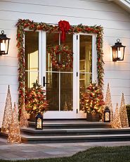 Patio decorated with Christmas lights and greenery