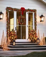 Patio decorated with Christmas lights and greenery