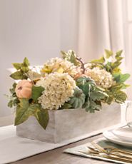 Artificial flower arrangement with hydrangeas, pumpkins, and mixed leaves
