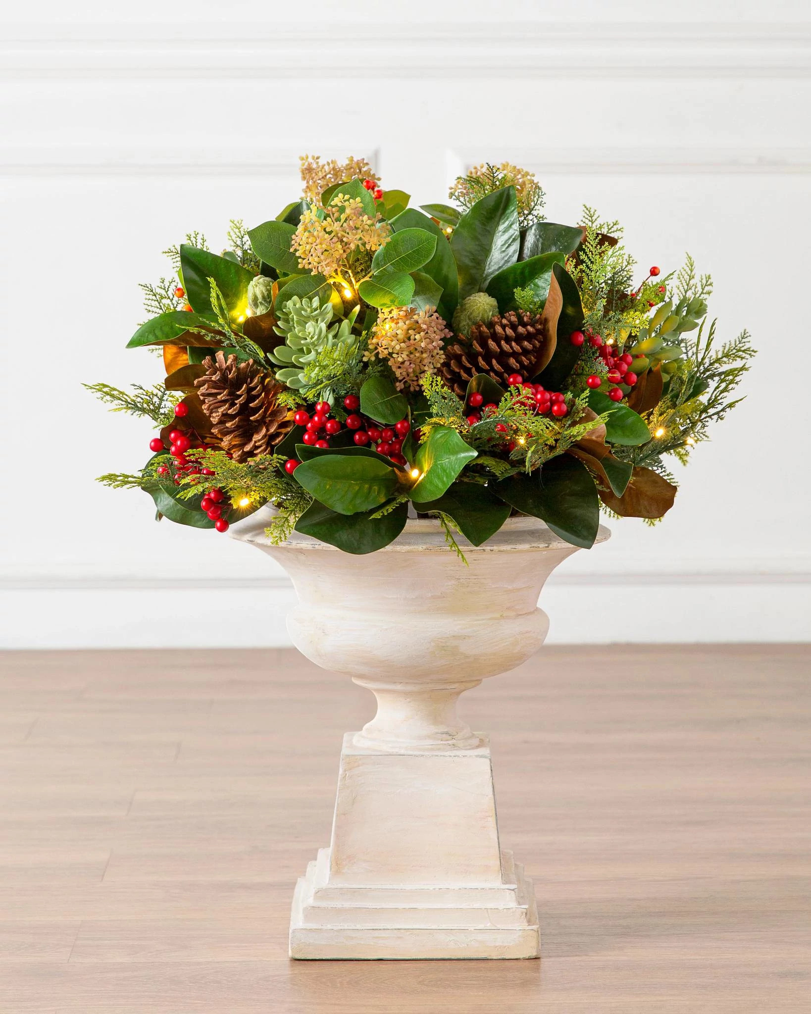 Potted artificial greenery magnolia with red berries and pinecones