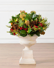 Potted artificial greenery magnolia with red berries and pinecones