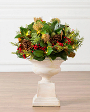 Potted artificial greenery magnolia with red berries and pinecones