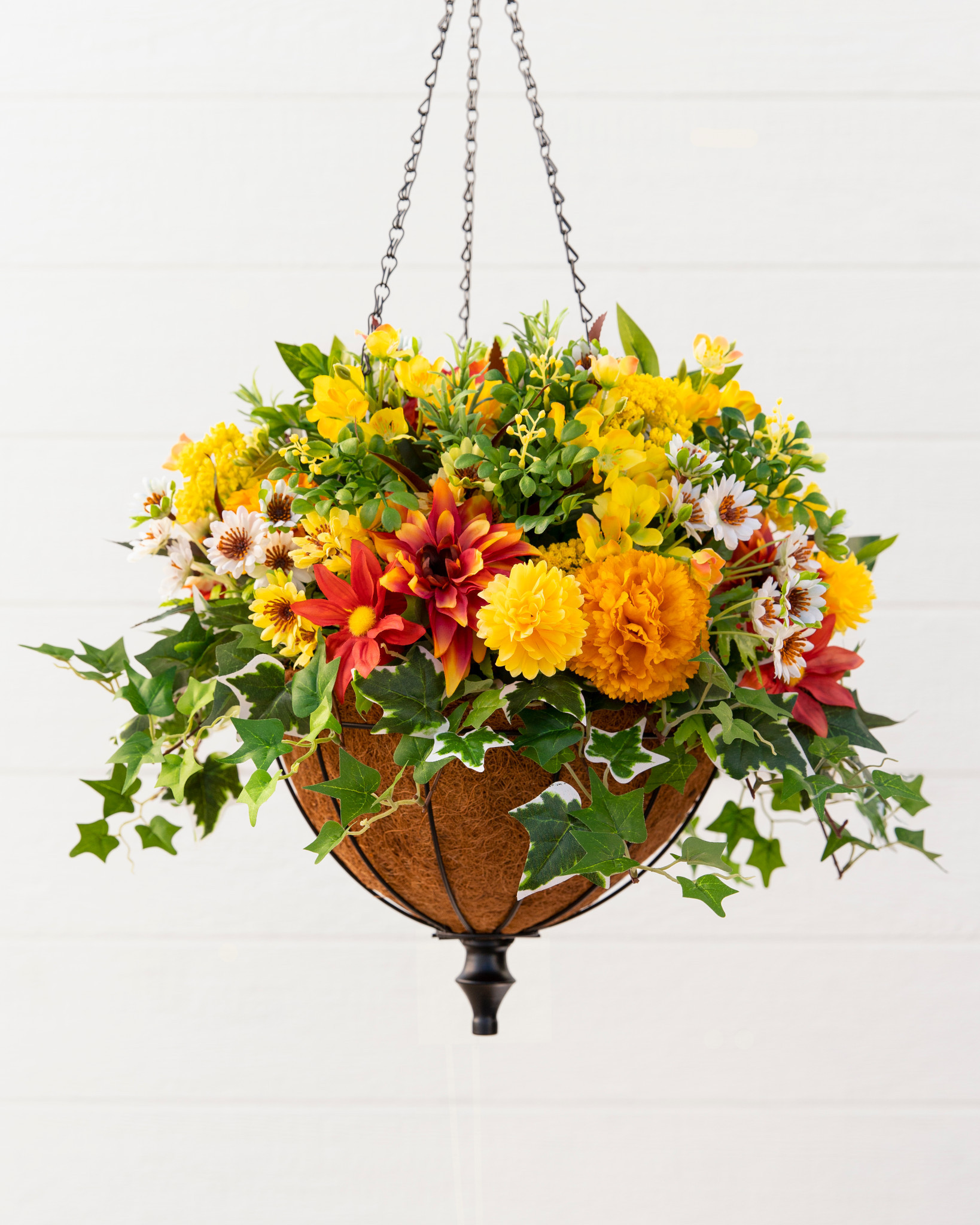 Closeup of a hanging basket with artificial flowers and foliage