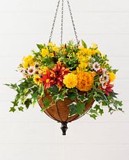 Closeup of a hanging basket with artificial flowers and foliage
