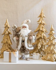 Gold Christmas trees next to Santa Claus