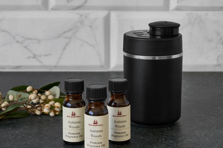 A fragrance machine next to small bottles of scented oils