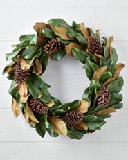 an unlit artificial wreath with faux apple and berry accents