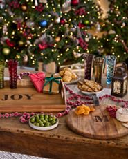 Christmas-themed tablescape with wooden trays and assorted fruits