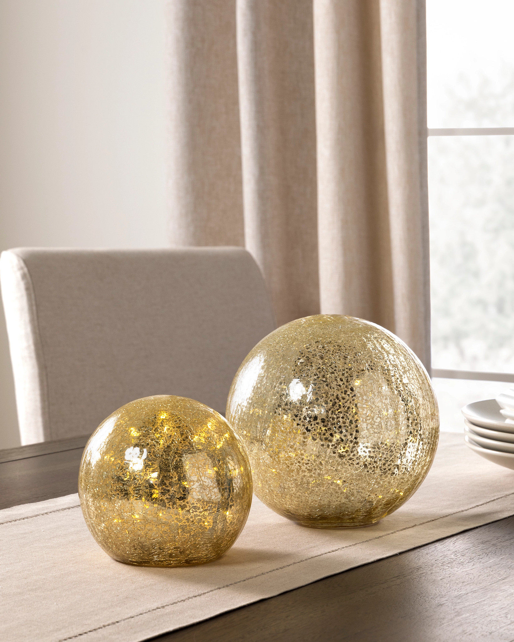 Pair of mercury glass orbs with fairy lights