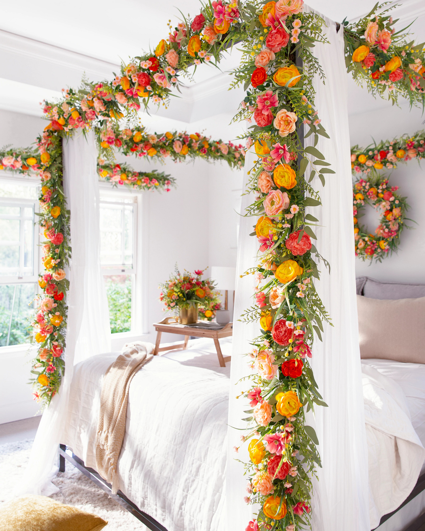 Bedroom with four-poster bed decorated with artificial garland and wreath