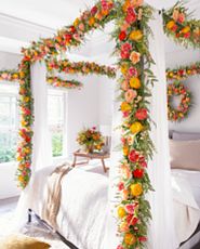 Bedroom with four-poster bed decorated with artificial garland and wreath