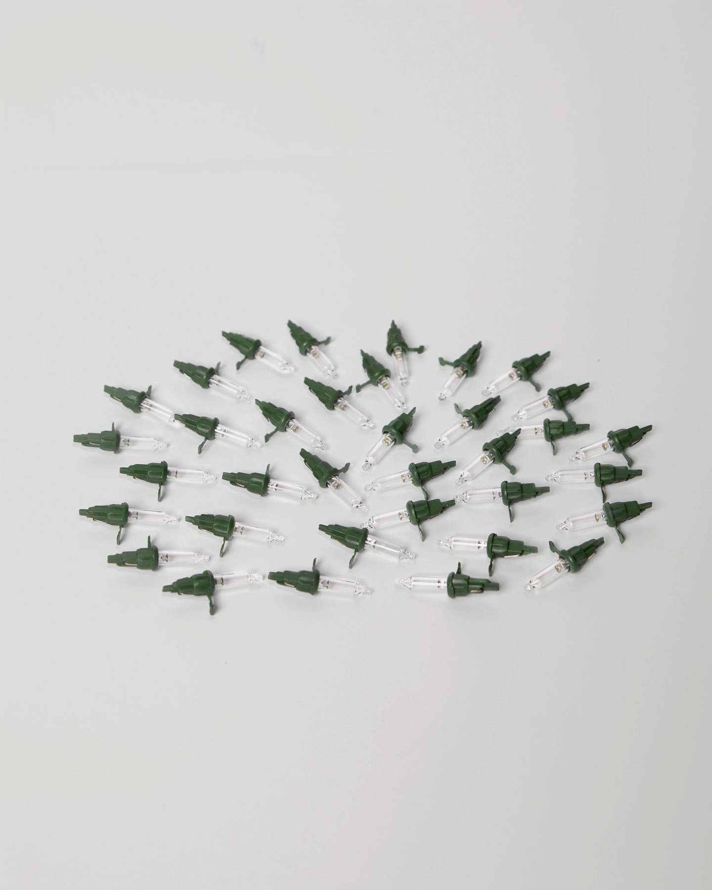 Balsam Hill Christmas Light Bulbs LED Clear Lights with Green Base Set of 35 arranged in a scattered pattern.