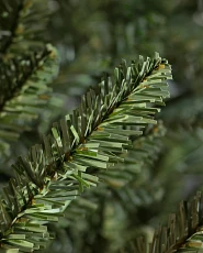 Close-up of artificial Christmas tree branch with PVC needles