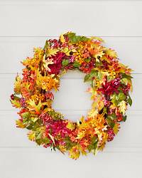 Autumn wreath with maple leaves, dahlias, and wildflowers