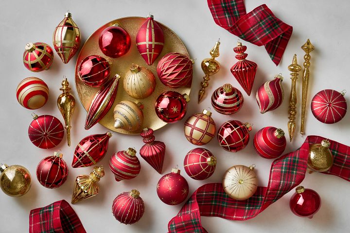 Assorted red and gold Christmas ornaments with red and green plaid ribbon