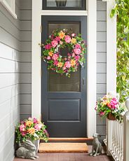 Gray front door with a floral wreath