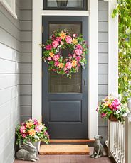 Gray front door with a floral wreath