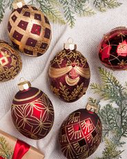 Set of burgundy and gold egg-shaped Christmas baubles