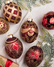 Set of burgundy and gold egg-shaped Christmas ornaments