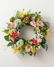 Artificial flower wreath with poppies, orchids, cherry blossoms, and tulips