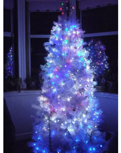 White christmas tree top with purple lights