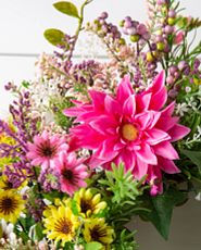 Closeup of pink and yellow artificial flowers and foliage