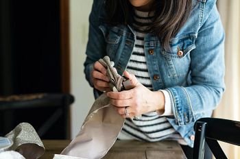 Woman shaping metallic Christmas ribbons