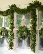 Wreaths and garlands placed over an exterior window